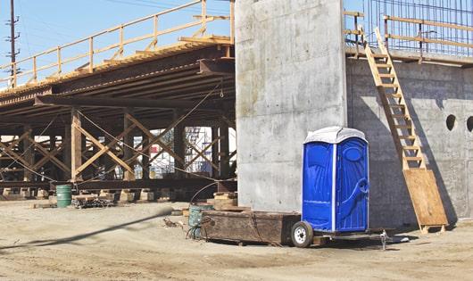 row of porta potties on a busy job site